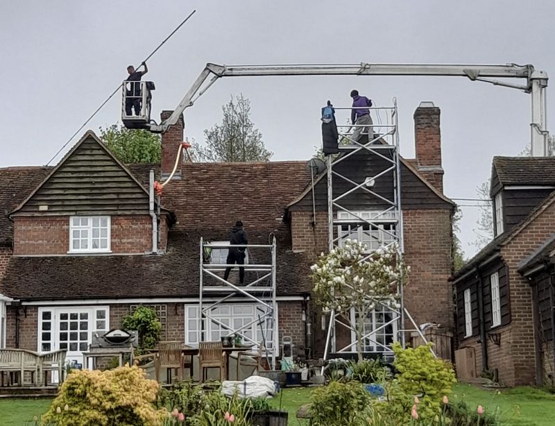 The Moss Cleaners using cherry picker and scaffolding to clean roof safely and professionally in Alcester, Warwickshire